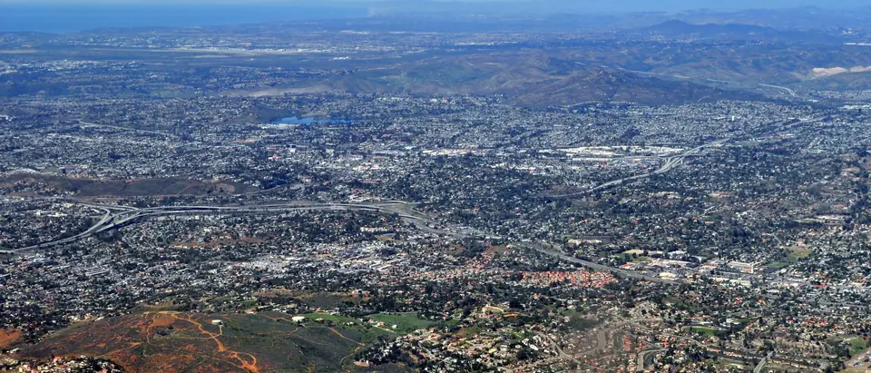 Homes across La Mesa and El Cajon seen from the air, with hills behind