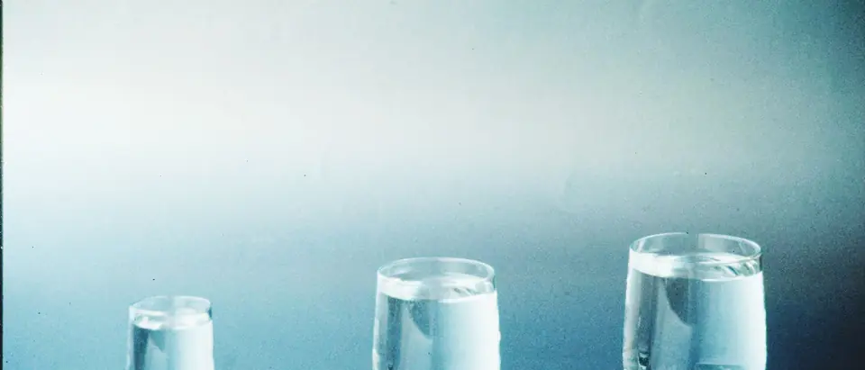 Three glasses of different sizes filled with water