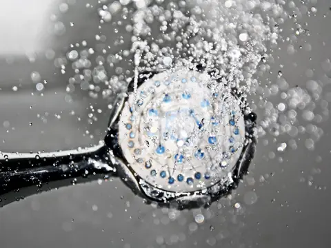 Water spraying from a round shower head
